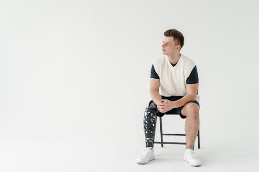 Man with a bionic prosthetic leg sitting in a minimalist room. Technology in everyday life.